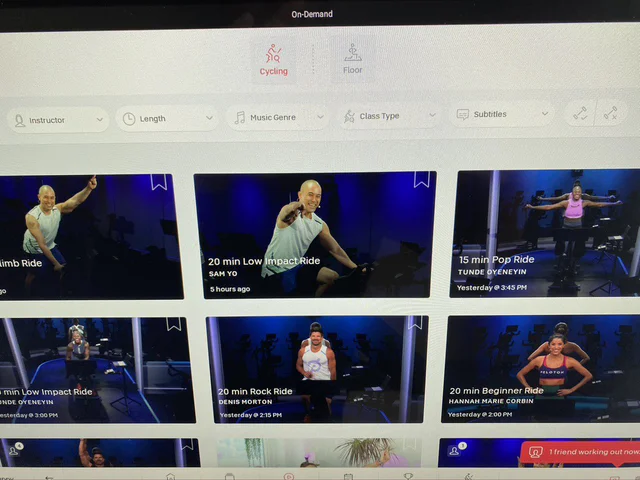 On-demand class library on a Peloton screen, with filters for instructor, length and music genre above a grid of ride classes