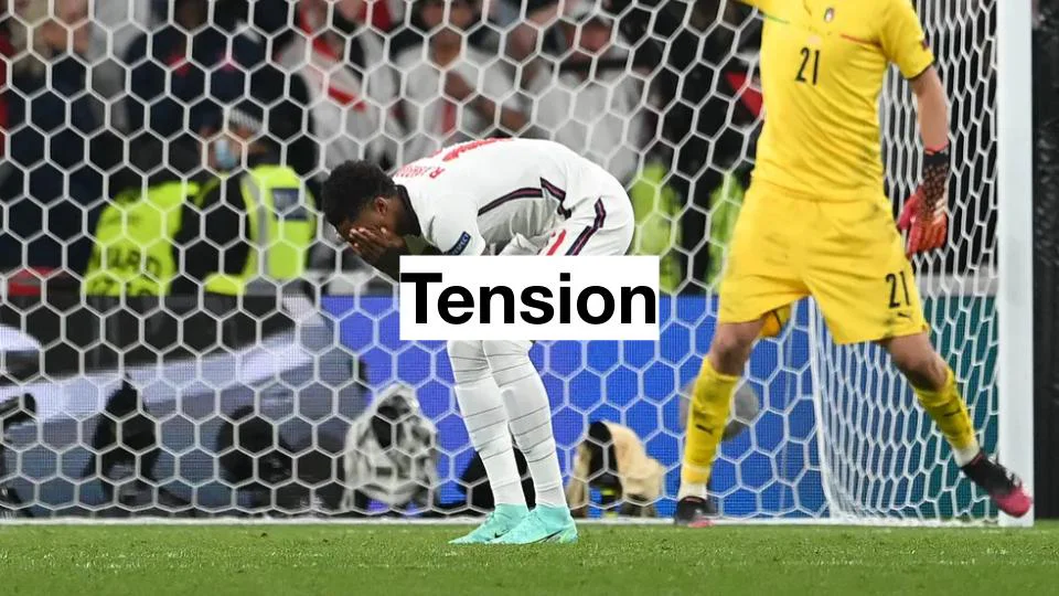 Slide titled Tension, a footballer with his hands over his face after a missed penalty
