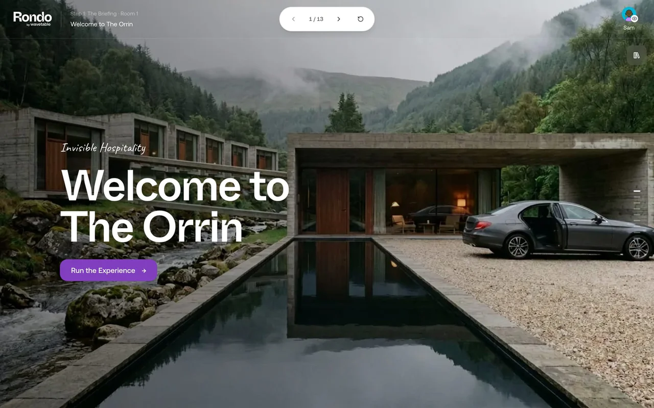 The opening screen of Invisible Hospitality: a concrete hotel in a misty valley, a long pool, and the words Welcome to The Orrin.