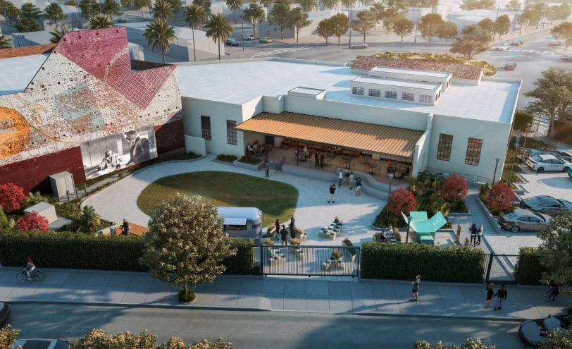 Aerial rendering of the Lighthouse campus, with a courtyard lawn, a covered cafe and a large mural on one building.