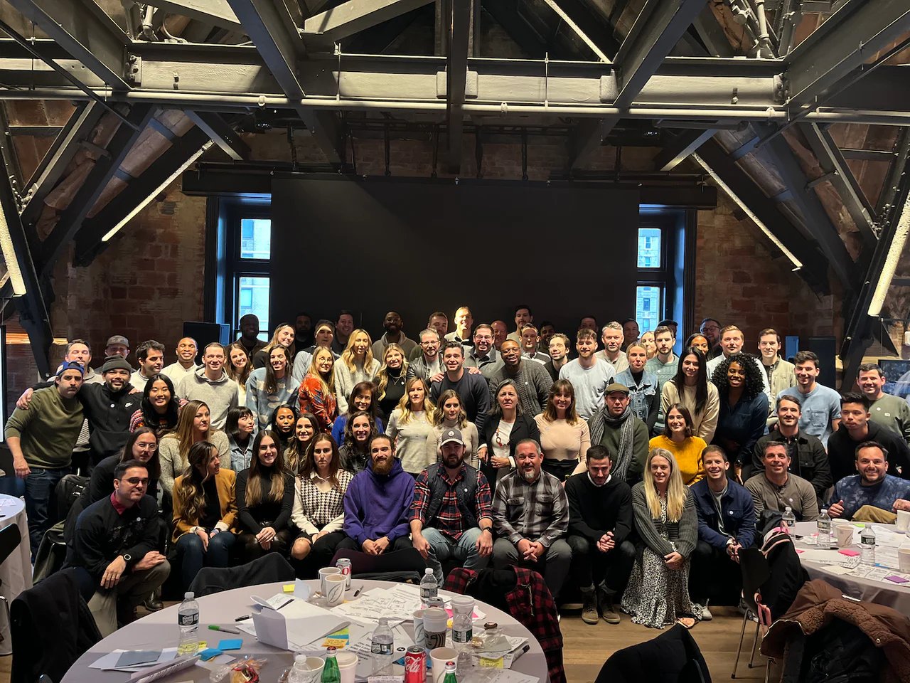 The Wasserman team together in the Loft at Fotografiska, under exposed beams, around round tables